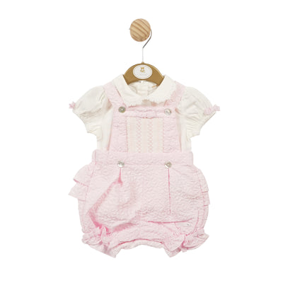 This girls' pink smocked top and bloomer dungaree set is essential for the spring/summer season. Its intricate smocked design and delicate ruffle detail on the back add an elegant touch. With a cute small pink bow detail on the arms, this charming set is available in sizes from 3 to 24 months. Make a statement with this adorable outfit.