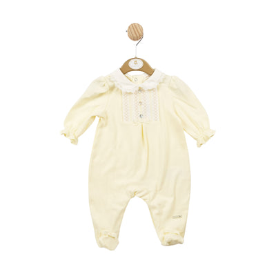 This girls smocked design lemon all in one sleepsuit is the perfect choice for your little one. With its Mintini Baby branding and charming smocked detail, it exudes style and comfort. The push button fastening on the reverse makes dressing a breeze. Available in sizes 1 month to 6 months.