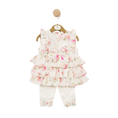 This girls ivory & floral two piece Tunic and legging set from Mintini Baby is both sweet and stylish. The ivory and floral pattern adds a pop of colour, while the bow detail and ruffle design add a touch of femininity. Button fastening on the reverse of the tunic top. Sizes available for babies up to 5 years, this set is perfect for any little fashionista.