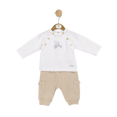 This Mintini Baby two piece set is perfect for your little boy's autumn and winter wardrobe. The long sleeve white top features a charming bicycle motif on the front, with button detailing on the side. The beige trousers have pockets on the legs, adding a stylish touch. Available in sizes 3 months up to 24 months.
