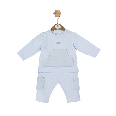 Get your little boy ready for the colder weather with our boys blue two piece jogsuit from the Mintini Baby autumn winter collection. This stylish outfit includes a long sleeve top and cargo style trousers, both featuring a unique towelling pocket detail. Available in sizes 3 months to 5 years, this outfit is both trendy and comfortable.