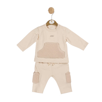 Introducing our boys beige two piece towelling jogsuit, from Mintini Baby. This stylish jogger outfit features a long sleeve top with a unique towelling pocket detail and elasticated waistband on the trousers. The cargo-style design trousers includes towelling pocket details on the legs. Available in sizes 3 months to 5 years, it's the perfect matching set for little and big brothers alike.