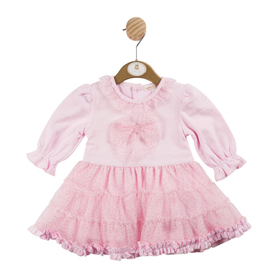 This girls pink long sleeve dress by Mintini Baby is the perfect addition to your child's autumn/winter wardrobe. The dress features a cute pink colour, delicate lace frill detailing on the collar and bottom, as well as a stylish bow in the middle. Available in sizes 3 months to 24 months.