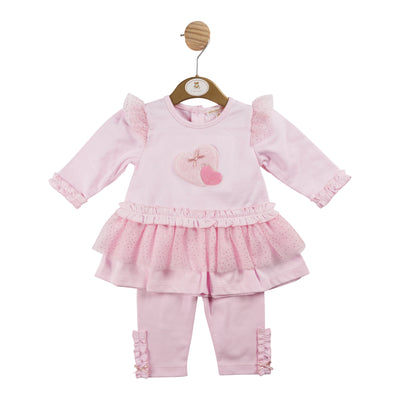 Introduce your little girl to Mintini Baby's new autumn winter collection with this adorable girls boutique outfit - pink heart tunic &amp; legging set. The pink two piece outfit features a long sleeve tunic top with a heart motif and lace frill detail, paired with cute leggings with details on the ankles. Available in sizes 3 months to 5 years, it's perfect for matching with a big sister and little sister outfit.