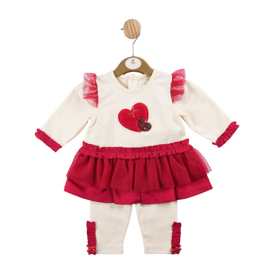 This Mintini Baby branded tunic and legging set is the perfect choice for the upcoming autumn and winter seasons. The ivory and red colour combination, heart motif detail, and frill accents make it both stylish and festive for the holiday season. Available in sizes 3 months to 5 years, perfect matching option for little sisters and big sisters.