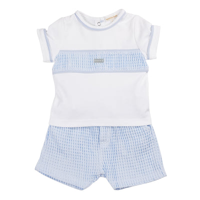 Introducing our new arrival for boys - the Mintini Baby two piece top and shorts set! The white top features a trendy blue band across the chest and blue piping details, paired with comfortable blue shorts with drawstrings. Available in sizes 3 months to 24 months. Perfect for any little gentleman.