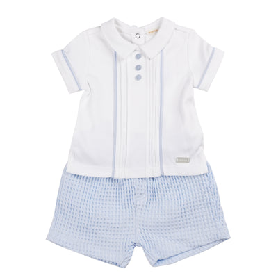 Introducing our new arrival from our spring summer collection - the boys white &amp; blue polo shirt and shorts set. This two piece set is perfect for your little one, featuring a stylish white shirt with a unique collar design and blue piping detail. The blue shorts have an elasticated waistband for a comfortable fit. Available in sizes 3 months to 24 months.