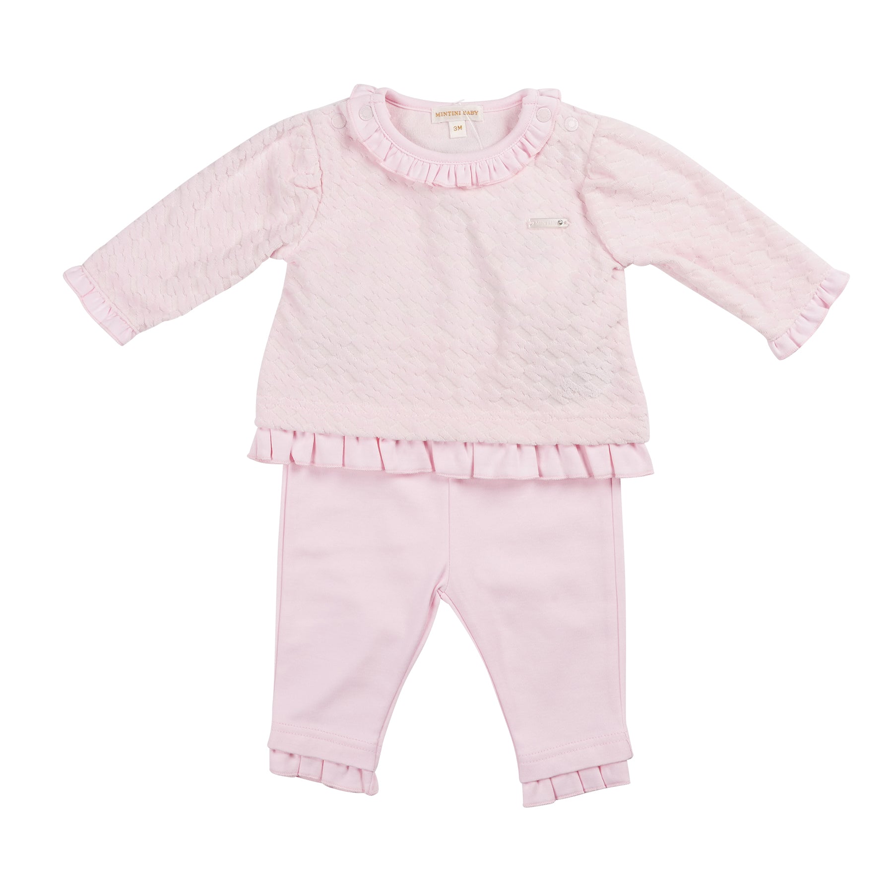 Introducing our new season arrival, the girls pink short tunic top & legging set from childrenswear boutique brand, Mintini Baby. This girls two piece outfit is part of our spring summer collection, and it offers a stylish and comfortable option for your little girl. The pink tunic top features a round neck collar and delicate frill details, while the leggings have an elasticated waistband for a perfect fit. Available in sizes 3 months to 24 months.