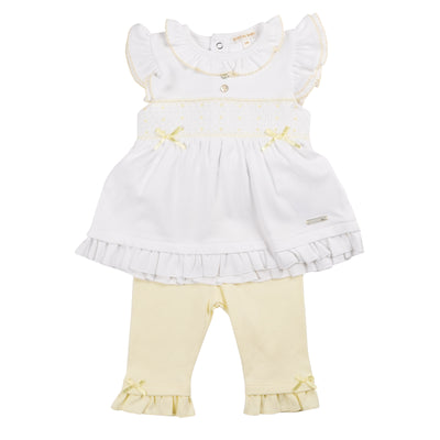 Introducing the new arrival from Mintini Baby - the girls lemon &amp; white smocked tunic and legging set. This two piece set features a white short sleeve tunic with a yellow smocked band and cute bow detail, along with a frilly collar. Complete the look with the lemon leggings that have a stylish frill around the ankle. Available in sizes 3 months to 24 months, this set is perfect for Easter or the spring/summer season.