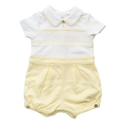 Introduce your little boy to style with our new Mintini Baby branded white &amp; lemon smocked short sleeve romper. Featuring a smocking design and a small peter pan style collar, this romper is perfect for Easter or for summer days ahead. With button fastening on the back and elasticated around the legs, it's comfortable and easy to wear. Available in sizes 3-12 months.