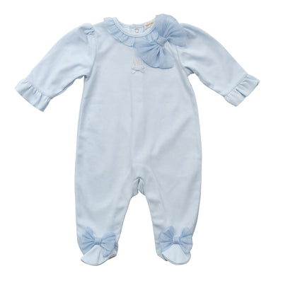 Introducing our new arrival from Mintini Baby's spring summer collection. Our all in one sleeper for baby girls comes in a beautiful pastel blue colour with ruffle detail and a large bow on the side. With push button fastening on reverse, available in sizes 1, 3, and 6 months.