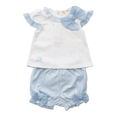 Get your little one ready for summer with this adorable girls white &amp; blue two piece top and bloomer shorts set from the childrens' boutique brand, Mintini Baby. This girls outfit is part of their spring summer collection. It consists of a white short sleeve t-shirt which features a cute blue ruffle detailing and a large decorative bow on the side. Paired with the comfy blue shorts, complete with elastic waistband and bow details, this set is perfect for sizes 3 months to 24 months.