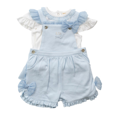 Introducing Mintini Baby's new arrival for the spring/summer collection: a beautiful white and blue top and short dungaree set with bow detail. The white short sleeve t-shirt features a delicate ruffle around the neck, while the blue dungaree showcases a crossover design on the back with a ruffle and large bow. Available in sizes 3 months to 24 months for your little girl.