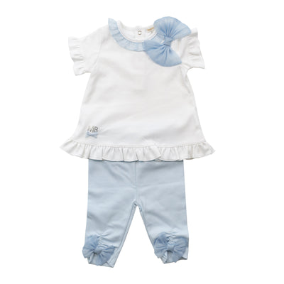 Dress your little girl in style with our girls white &amp; pastel blue two piece tunic top and legging set. This adorable Mintini Baby branded outfit includes a white short sleeve tunic top with a cute blue ruffle around the neck and a large bow to the side, paired with matching blue leggings featuring bows on the legs. Available in sizes 3 months to 24 months.