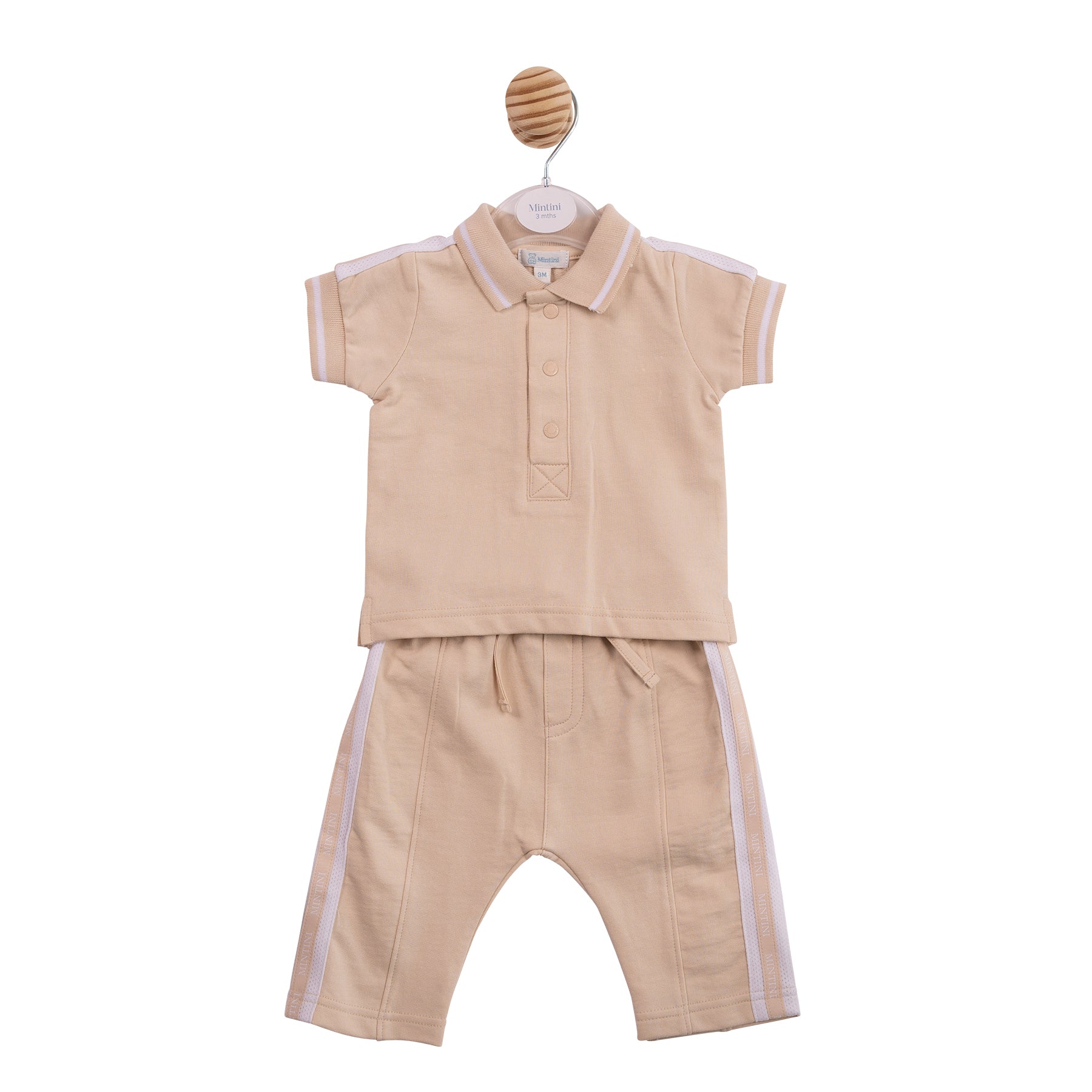 Technical flat lay front view of the Mintini boys beige and white two-piece polo and trouser set.