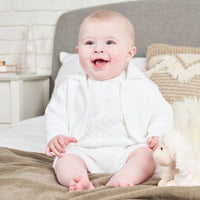 This Dandelion branded unisex white button up cardigan is perfect for both boys and girls. The added collar detail adds a touch of sophistication to this classic piece. Available in sizes newborn to 12 months, this cardigan is a versatile and timeless addition to any child's wardrobe.