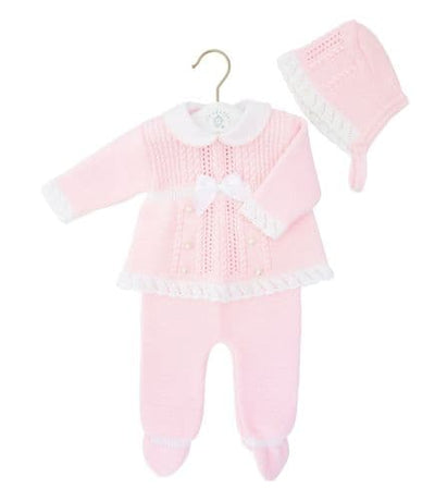 Baby girls pink three piece knitted set by baby clothing brand Dandelion. This set consists of a knitted collar top which has button and bow detail to the front, closed feet trousers and a bonnet hat to match. Available in sizes 0-3 month, 3-6 month & 6-12 month. 100% acrylic. 