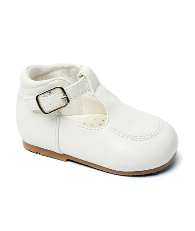 These boys' traditional T-bar shoes feature a stylish and versatile white matt finish, along with a supportive ankle design and cushioned inner sole for added comfort. The buckle fastening ensures a secure fit. Designed by Sevva as part of their new spring/summer collection, available in sizes 2-8.