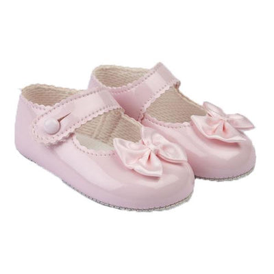 These gorgeous pink pre-walker baby girl shoes, from our Baypods collection, are beautifully made in soft faux patent leather and have pretty satin bows on the toes. Easy to put on, they secure with a button fastening strap. They have a lightly cushioned insole and their flexible soles are just right for developing feet.  . Faux patent leather Lightly cushioned insole  Flexible soles Button fastening strap