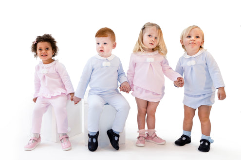 Kidz Emporium premium childrenswear mystery box clearance stock - illustrative lifestyle example of traditional baby boy and girl knitted outfit