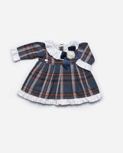 Blue & burnt orange printed tartan dress by Juliana. The front of the dress has a fur pom with navy ribbon detail, and white collar with white cuffs on the sleeves. This Spanish dress is available in sizes 3m up to 3yr.