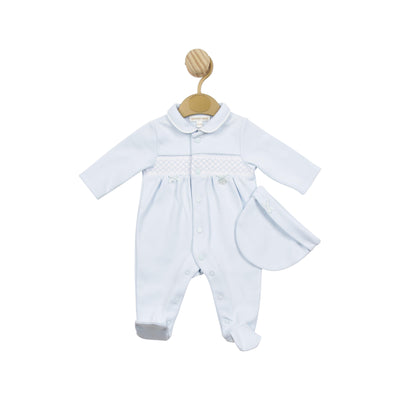 Premature baby boys blue and white all in one sleep suit and matching hat by baby boutique brand Mintini Baby. This set has a smocked detail going across the middle. Available in sizes 3/5lb, 5/8lb &amp; newborn size.